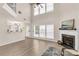 Bright living room boasts high ceilings, fireplace, hardwood floors, and large windows at 355 Pintail Ct, Suwanee, GA 30024