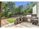 Outdoor kitchen with built-in grill, side burner, and countertop space at 355 Pintail Ct, Suwanee, GA 30024