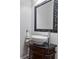 Elegant powder room featuring vessel sink, dark vanity, and decorative framed mirror at 1003 Pearl Ne Pt, Sandy Springs, GA 30328