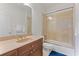 Well-lit bathroom with a brown vanity, sink, and a glass-enclosed shower with tile surround at 1003 Pearl Ne Pt, Sandy Springs, GA 30328