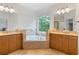 Bright bathroom with granite countertops, vanities, and a soaking tub at 1003 Pearl Ne Pt, Sandy Springs, GA 30328