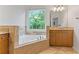 Bright bathroom with a large soaking tub and granite countertops at 1003 Pearl Ne Pt, Sandy Springs, GA 30328