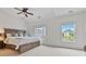 Spacious bedroom with a large bed, ceiling fan, and bright windows at 1003 Pearl Ne Pt, Sandy Springs, GA 30328