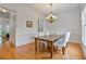 Dining room features hardwood floors, a large window, wainscoting, and a chandelier at 1003 Pearl Ne Pt, Sandy Springs, GA 30328