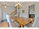Open dining room with a wood table, chandelier, hardwood floors and staircase in view at 1003 Pearl Ne Pt, Sandy Springs, GA 30328