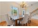 Dining room features hardwood floors, chandelier, and a large window with natural light at 1003 Pearl Ne Pt, Sandy Springs, GA 30328