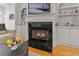 Inviting fireplace with black tile surround and built-in shelving in the living room at 1003 Pearl Ne Pt, Sandy Springs, GA 30328