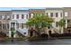Charming townhomes featuring brick and siding exteriors, manicured landscaping and tree-lined street at 1003 Pearl Ne Pt, Sandy Springs, GA 30328