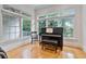 Bright sun room with hardwood floors and piano by large windows at 1003 Pearl Ne Pt, Sandy Springs, GA 30328