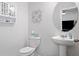 Stylish powder room with a pedestal sink and decorative wall art at 117 Point View Dr, Canton, GA 30114