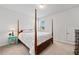 Cozy bedroom featuring carpet, a wood framed bed, and natural light from a window at 117 Point View Dr, Canton, GA 30114