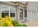 Charming home entrance with a gray painted door and window, plus garage doors, and manicured bushes at 117 Point View Dr, Canton, GA 30114