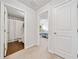 Hallway featuring carpet leading to a bathroom with wood floor and a bedroom with carpet at 117 Point View Dr, Canton, GA 30114