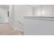 Bright hallway with neutral carpet, white walls, and trim, leading to a bedroom door at 117 Point View Dr, Canton, GA 30114