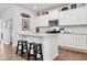 Modern kitchen featuring white cabinets, granite countertops, and a center island with barstool seating at 117 Point View Dr, Canton, GA 30114