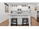 Modern kitchen with white cabinets, granite countertops, and a center island with stools at 117 Point View Dr, Canton, GA 30114