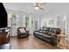 Comfortable living room features leather seating, a ceiling fan, and natural light at 117 Point View Dr, Canton, GA 30114