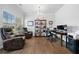 Spacious office with leather recliners, a desk, and ample bookshelf storage at 117 Point View Dr, Canton, GA 30114