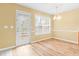 Dining area with hardwood floors, and a glass panel door to the outside at 2457 Swan Lake Dr, Grayson, GA 30017