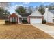 Charming single-story home with a well-maintained lawn and a two car attached garage at 2457 Swan Lake Dr, Grayson, GA 30017