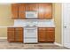 Kitchen features wooden cabinets, white appliances, and a white backsplash at 2457 Swan Lake Dr, Grayson, GA 30017