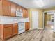 Kitchen features wooden cabinets, white countertops, and white appliances at 2457 Swan Lake Dr, Grayson, GA 30017