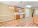 Eat in kitchen with hardwood floors, white appliances, and wood cabinets at 2457 Swan Lake Dr, Grayson, GA 30017