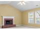 Cozy living room featuring vaulted ceiling, a fireplace, and abundant natural light at 2457 Swan Lake Dr, Grayson, GA 30017