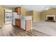 Cozy living room with fireplace adjacent to an open kitchen and hardwood floors at 2457 Swan Lake Dr, Grayson, GA 30017