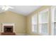 Bright living room featuring a brick fireplace and multiple windows at 2457 Swan Lake Dr, Grayson, GA 30017