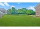Expansive backyard featuring lush green grass and mature trees at 468 Scott Farm Dr, Powder Springs, GA 30127