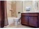 Bathroom with a shower, tile floors, a dark vanity, and a large framed mirror at 468 Scott Farm Dr, Powder Springs, GA 30127