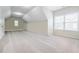 Large bonus room with two windows, neutral paint, carpeted floors, and a vaulted ceiling at 468 Scott Farm Dr, Powder Springs, GA 30127