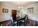 Formal dining room with a decorative rug, elegant lighting, and classic wainscoting at 468 Scott Farm Dr, Powder Springs, GA 30127