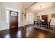 Elegant dining room featuring a beautiful chandelier, dark wood flooring, and large windows at 468 Scott Farm Dr, Powder Springs, GA 30127