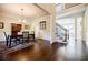 Bright dining area with a staircase, dark wood flooring, and an elegant chandelier at 468 Scott Farm Dr, Powder Springs, GA 30127