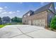 Home exterior featuring a large concrete driveway and a three-car garage at 468 Scott Farm Dr, Powder Springs, GA 30127