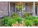 Inviting front porch with decorative plants and seating area at 468 Scott Farm Dr, Powder Springs, GA 30127