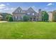 Charming two-story brick home with a stone chimney and a beautifully landscaped front yard at 468 Scott Farm Dr, Powder Springs, GA 30127