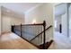 Hallway area featuring wooden railing, carpeted floor and view of adjacent rooms at 468 Scott Farm Dr, Powder Springs, GA 30127