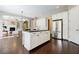 Open concept kitchen with island, stainless refrigerator, and access to living room at 468 Scott Farm Dr, Powder Springs, GA 30127