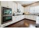 Modern kitchen with stainless steel appliances, white cabinets and tile backsplash at 468 Scott Farm Dr, Powder Springs, GA 30127