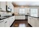 This kitchen showcases stainless appliances, sleek black countertops, and modern fixtures at 468 Scott Farm Dr, Powder Springs, GA 30127