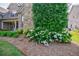 Beautiful landscaping with flowering shrubs and mature trees at 468 Scott Farm Dr, Powder Springs, GA 30127