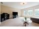 Open-concept living room with entertainment center, large windows, and comfortable seating at 468 Scott Farm Dr, Powder Springs, GA 30127