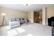 Bright living room with plush carpeting, modern furniture, and a view of the upper level landing at 468 Scott Farm Dr, Powder Springs, GA 30127
