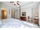 Bedroom featuring a four poster bed, tray ceilings, and ensuite bathroom at 468 Scott Farm Dr, Powder Springs, GA 30127
