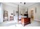 Bedroom with a four poster bed, tray ceilings, carpet, and lots of natural light at 468 Scott Farm Dr, Powder Springs, GA 30127