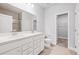 Well-lit bathroom featuring double vanity, framed mirror, and glass door shower at 470 Village Ln, Fairburn, GA 30213
