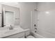 Simple bathroom with modern fixtures, a shower-tub, and a door leading to another room at 470 Village Ln, Fairburn, GA 30213